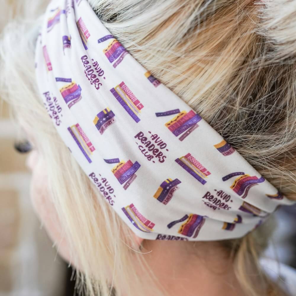 Avid Readers Club Headband with quote "Avid Readers Club" and stacks of multicolored books decorating the band