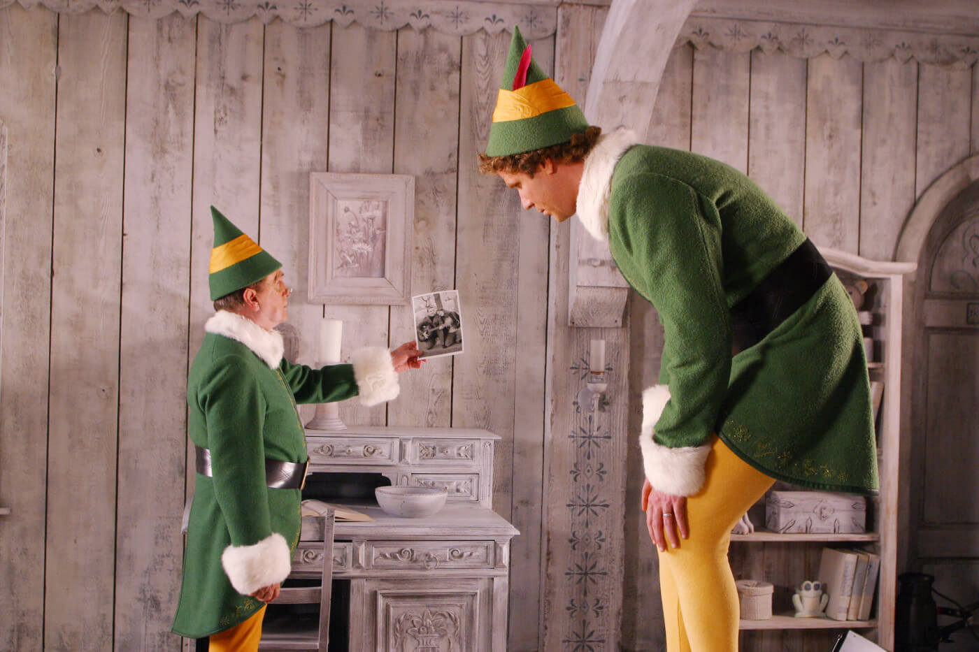 Buddy the Elf with his elf dad in Santa's workshop in the North Pole