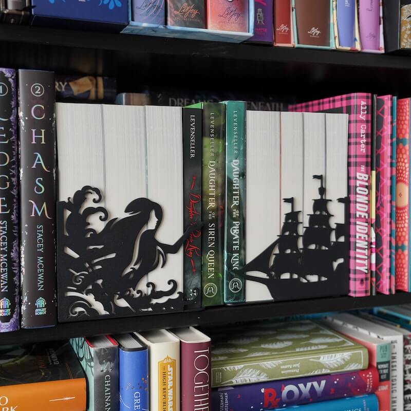 one bookend looks like a ship, the other side is a siren emerging from the sea