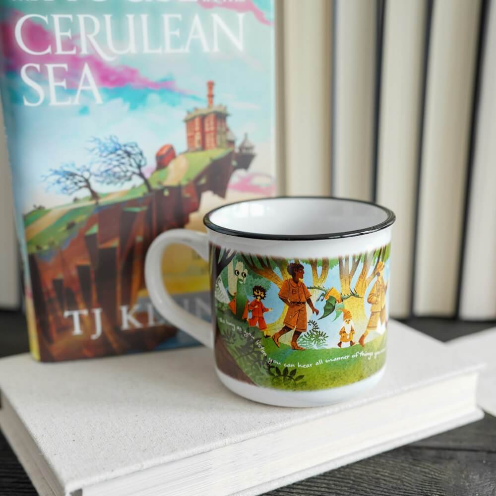 Cerulean Sea Mug has characters from T.J. Klune's book hiking on a grassy hill with the sea in background.