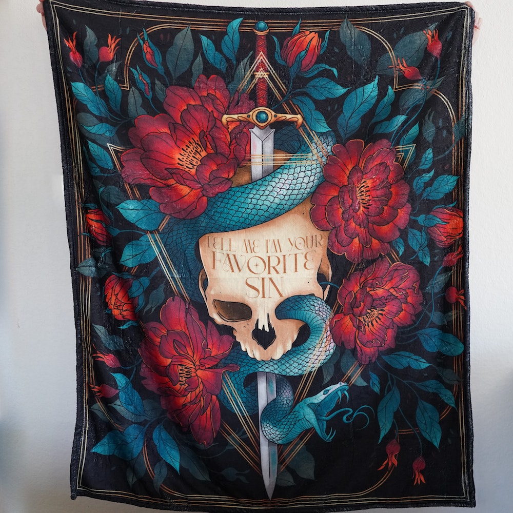 Skull w/ sword through top & a snake crawling through, red flowers & leaves around a quote: Tell Me I'm Your Favorite Sin