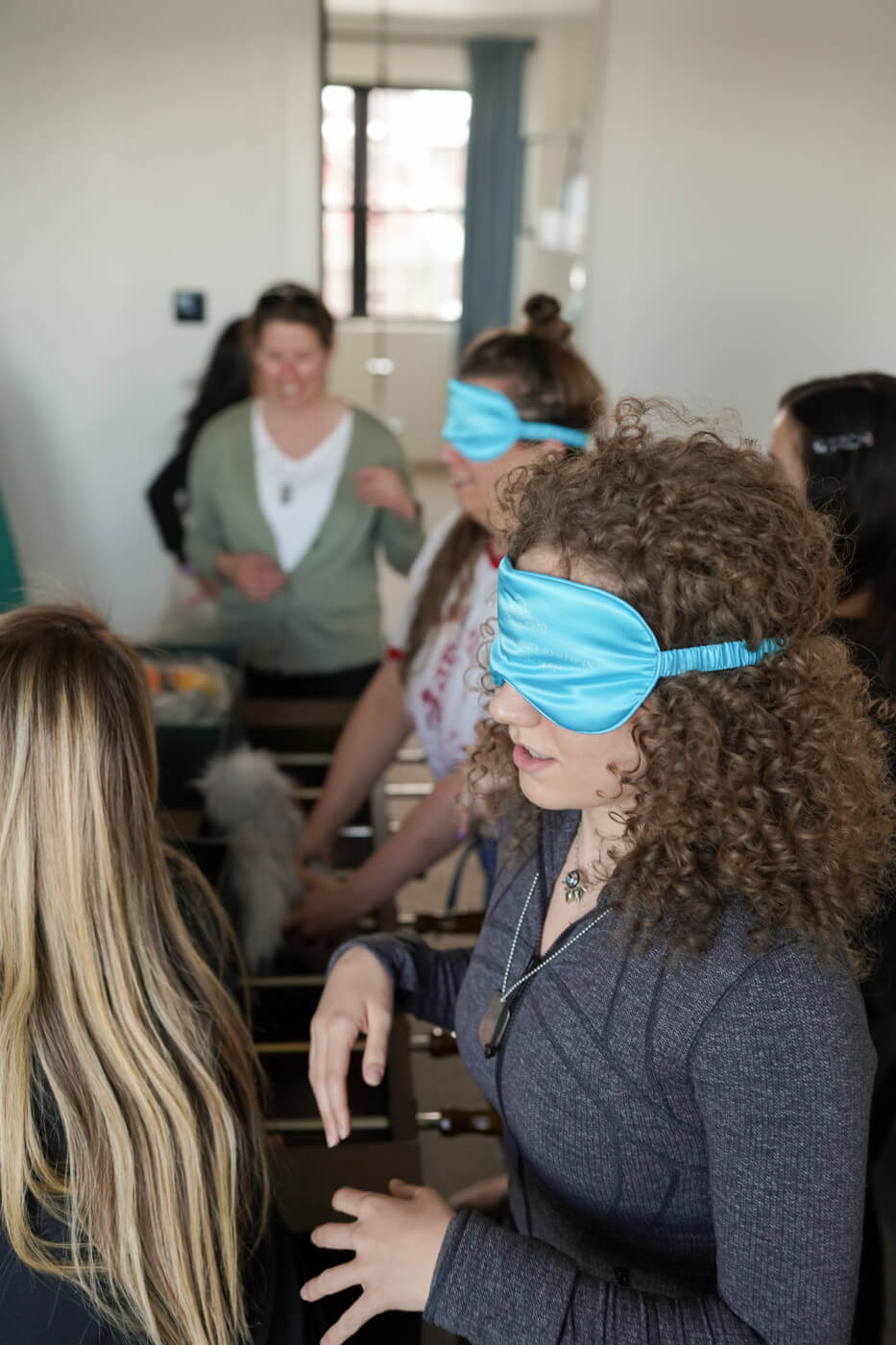 Sara and Erin blindfolded, Stefanie directing