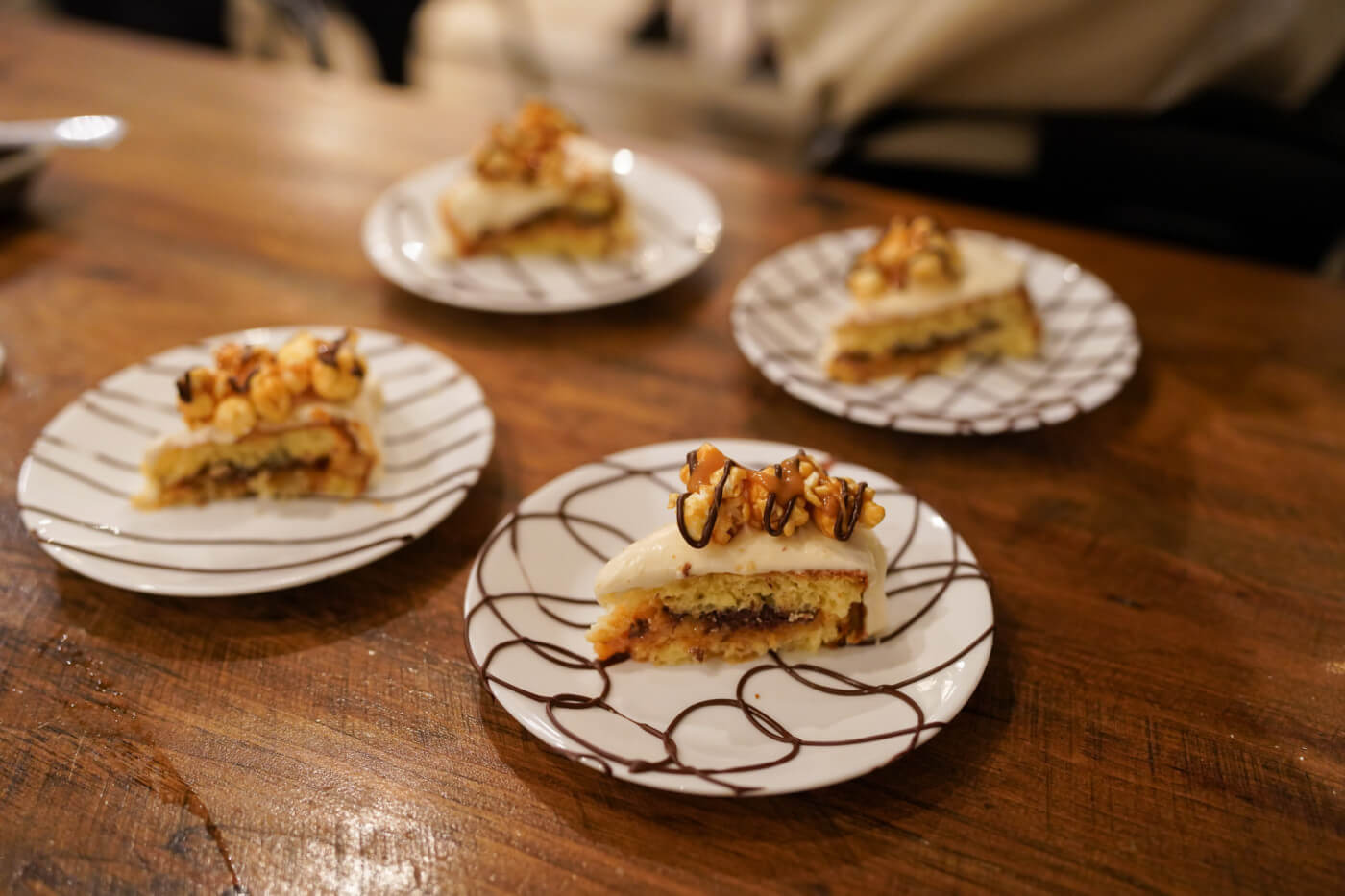 Caraval Caramel Corn Cake on plates with chocolate swirls