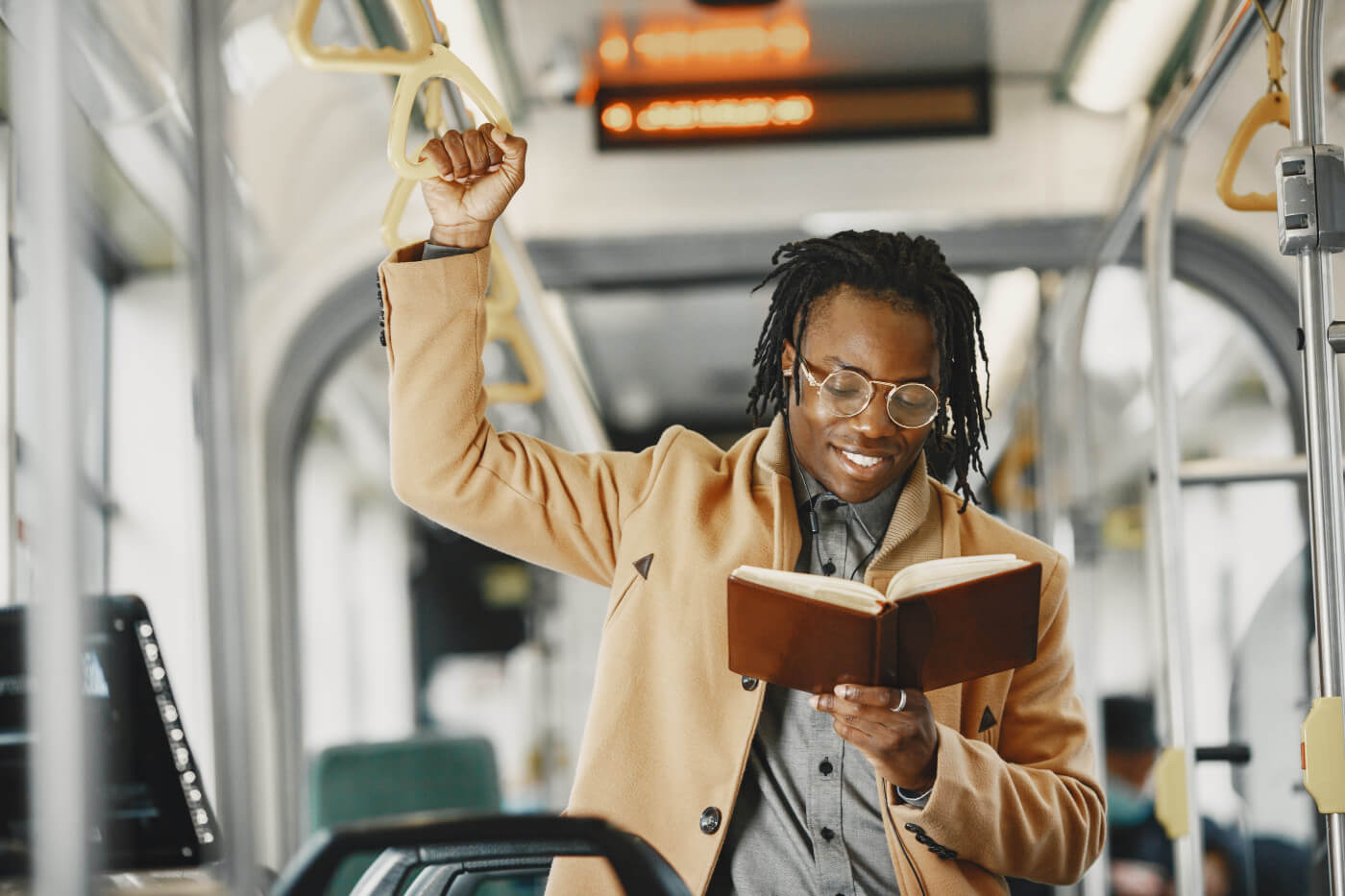 man reading on public transportation