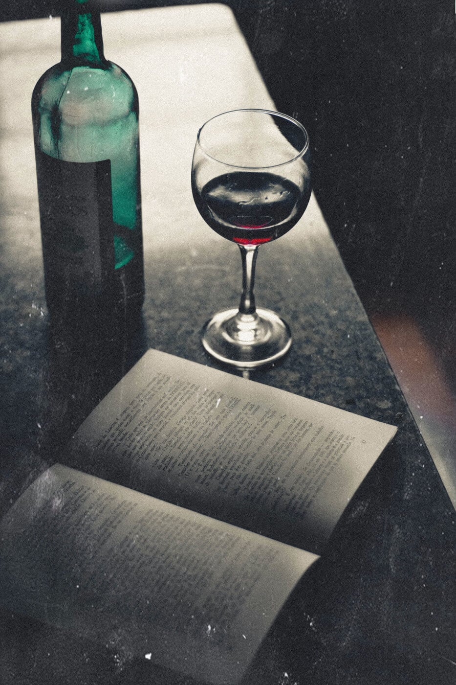 Glass of wine and book at a bar photo by Wallace Chuck