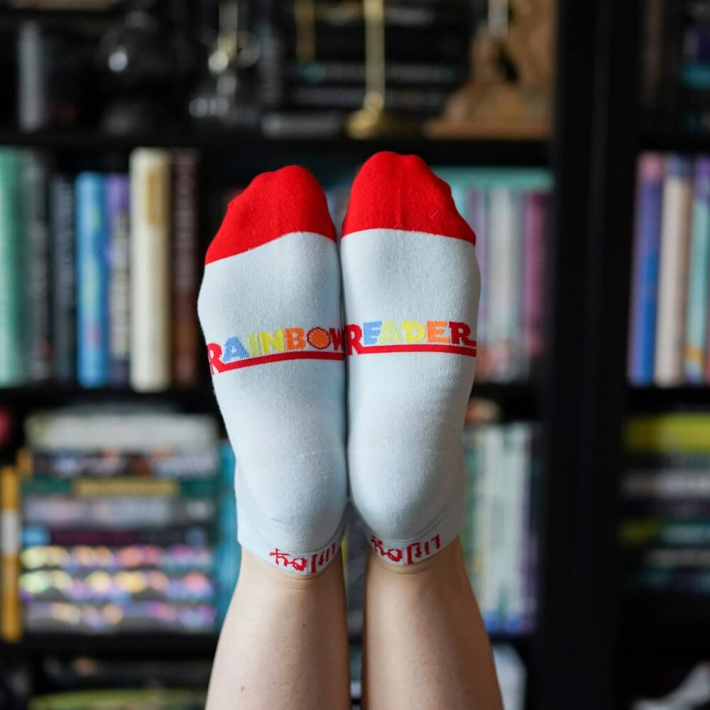 Rainbow Reader Socks have "Rainbow Reader" written in colorful letters