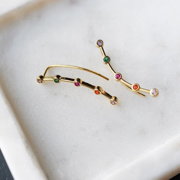 Red Queen Mare Barrow Crawler Earrings are gold with 5 rhinestones in pink, red, purple, green, and blood red.
