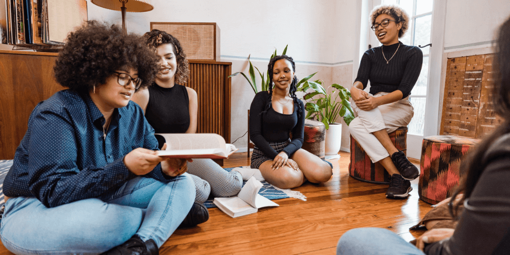 book club with women sitting on the floor with books