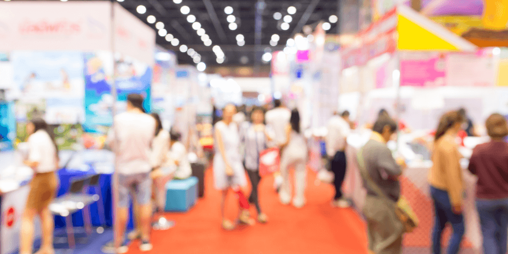 Book Convention blurred with people walking around and exploring vendors