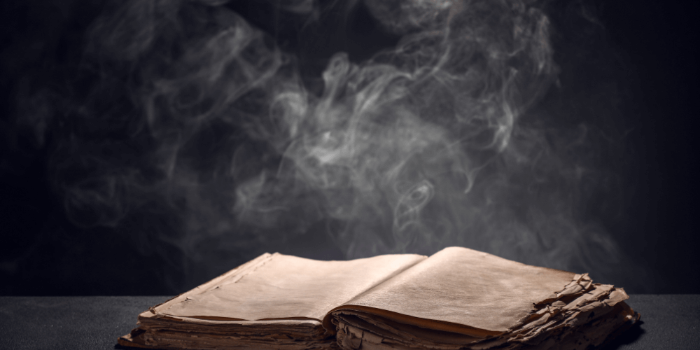 Magical books on a wooden table under a starry sky
